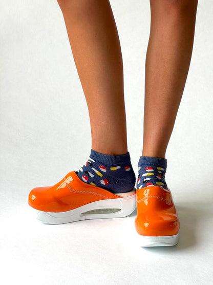 Airmeds solid orange lacquer clogs